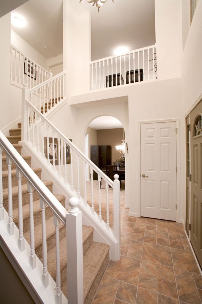 Modular home stairs with balcony in two story vaulted foyer the ...