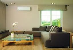 The air handler in the living room for this mini-split heating and cooling system is hung on the wall.